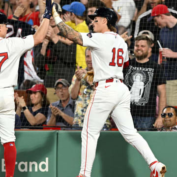 Jun 12, 2024; Boston, Massachusetts, USA; Boston Red Sox outfielder Jarren Duran (16) high-fives outfielder Tyler O'Neill (17)  during the fifth inning at Fenway Park. Duran scored on a RBI hit by O'Neill. Mandatory Credit: Brian Fluharty-USA TODAY Sports