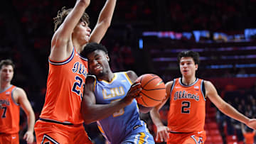 Nov 22, 2025; Champaign, Illinois, USA;  Long Island University Sharks forward Mason Porter-Brown (6) drives with the ball into Illinois Fighting Illini guard Keaton Wagler (23) during the second half at State Farm Center. Mandatory Credit: Ron Johnson-Imagn Images