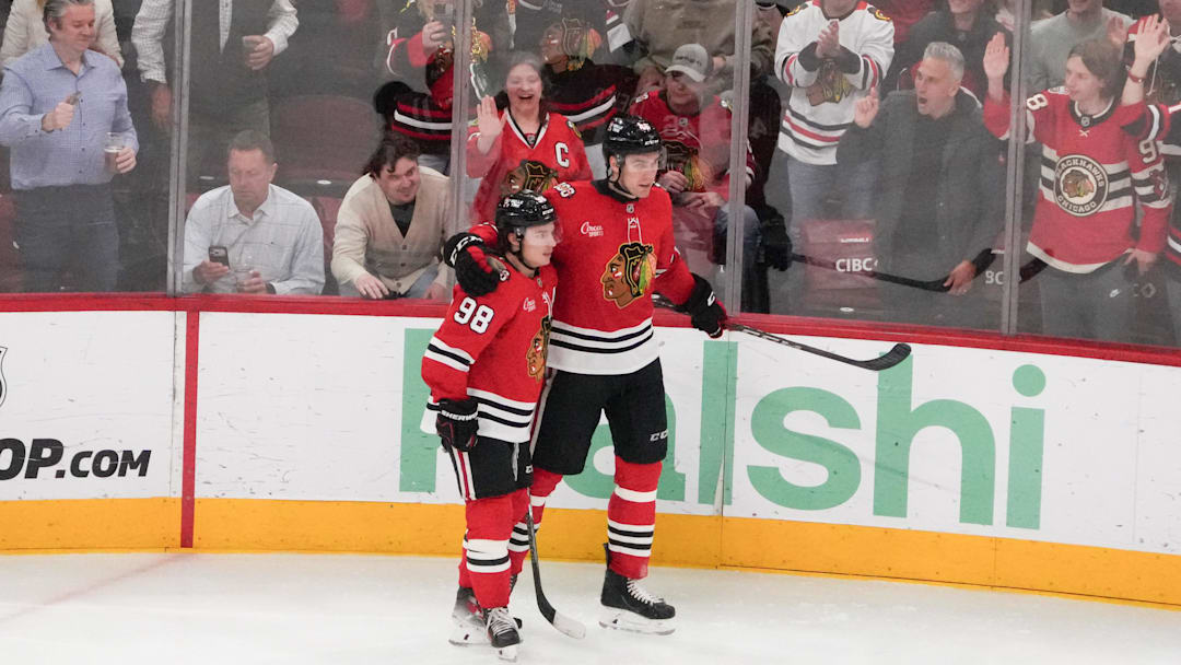 Apr 15, 2026; Chicago, Illinois, USA; Chicago Blackhawks defenseman Louis Crevier (46) celebrates his goal against the San Jose Sharks with center Connor Bedard (98)during the third period at United Center. Mandatory Credit: David Banks-Imagn Images