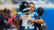 Jacksonville Jaguars defensive coordinator Anthony Campanile hugs safety Andrew Wingard (42) before an NFL football matchup at EverBank Stadium, Sunday, Sept. 21, 2025, in Jacksonville, Fla. The Jaguars defeated the Texans 17-10.