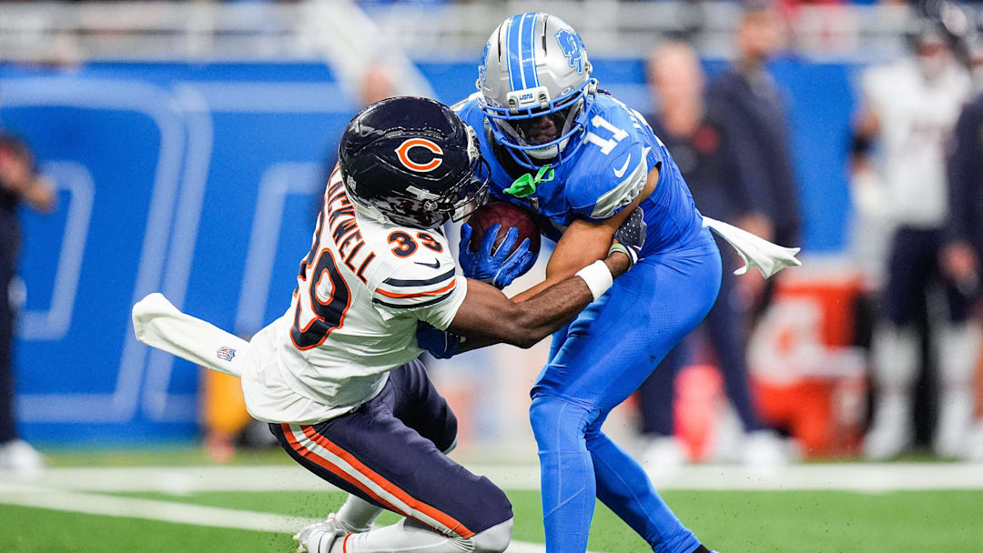 Chicago Bears cornerback Josh Blackwell (39) tackles Detroit Lions punt returner Kalif Raymond during the second half at Ford Field in Detroit on Sunday, Sept. 14, 2025.