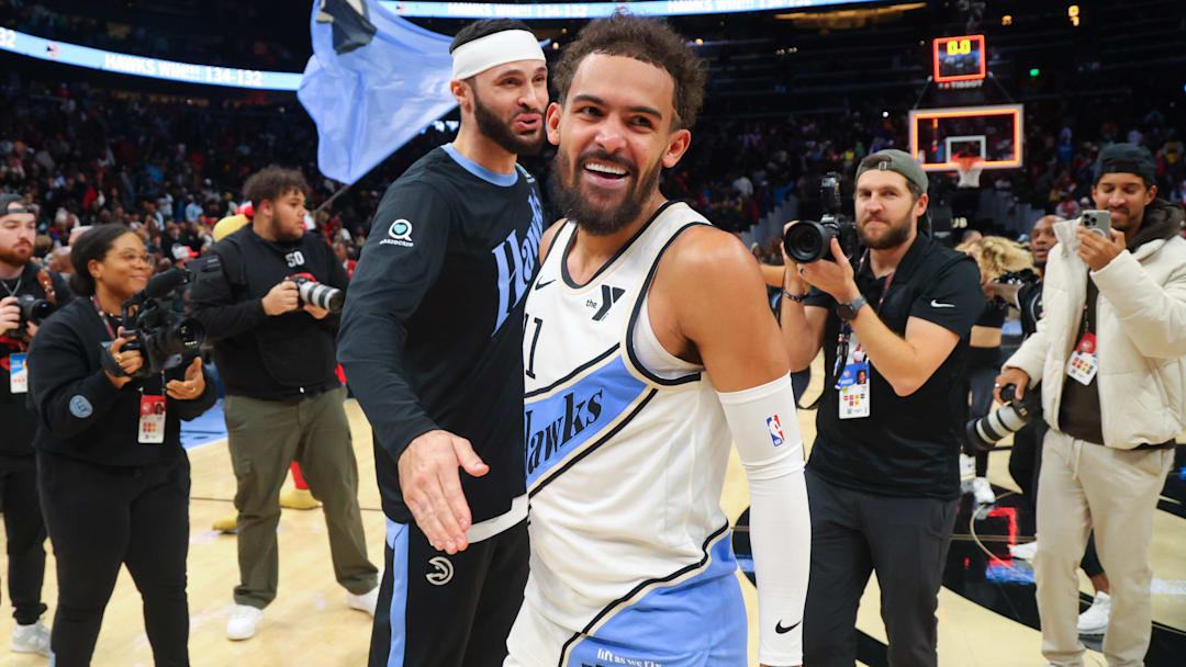 Dec 6, 2024; Atlanta, Georgia, USA; Atlanta Hawks guard Trae Young (11) celebrates with forward Larry Nance Jr. (22) after an overtime victory over the Los Angeles Lakers at State Farm Arena. Mandatory Credit: Brett Davis-Imagn Images
