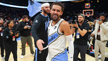 Dec 6, 2024; Atlanta, Georgia, USA; Atlanta Hawks guard Trae Young (11) celebrates with forward Larry Nance Jr. (22) after an overtime victory over the Los Angeles Lakers at State Farm Arena. Mandatory Credit: Brett Davis-Imagn Images
