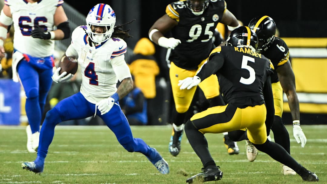Nov 30, 2025; Pittsburgh, Pennsylvania, USA; Buffalo Bills running back James Cook III (4) rushes as Pittsburgh Steelers cornerback Jalen Ramsey (5) defends
