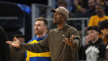 Apr 26, 2025; San Francisco, California, USA; Golden State Warriors forward Jimmy Butler III (center) yells from the bench against the Houston Rockets during the third quarter of game three of first round for the 2024 NBA Playoffs at Chase Center. Mandatory Credit: Darren Yamashita-Imagn Images
