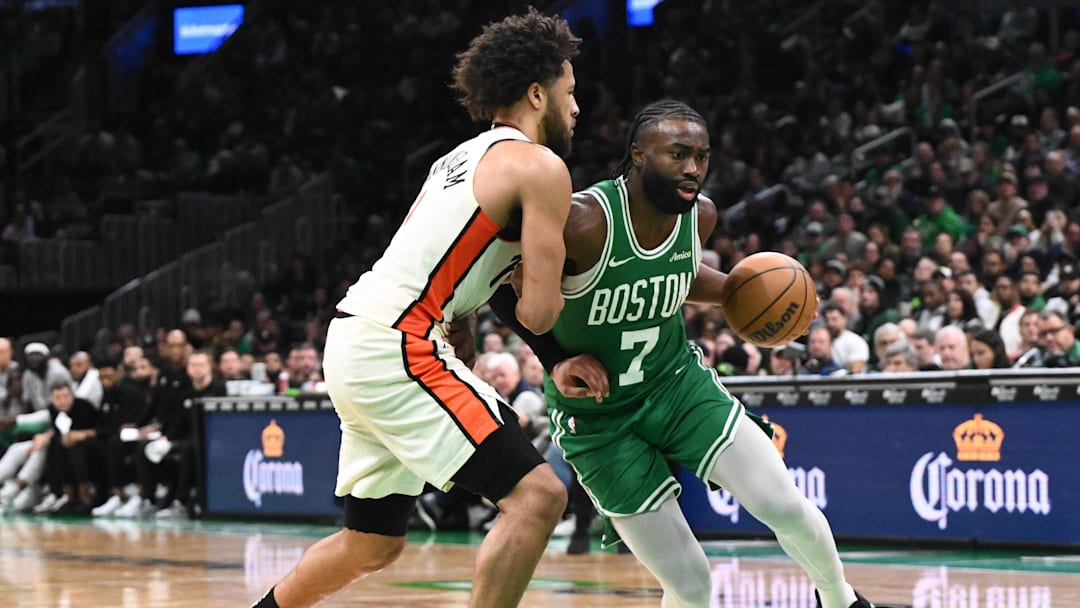 Dec 4, 2024; Boston, Massachusetts, USA; Boston Celtics guard Jaylen Brown (7) drives to the basket against Detroit Pistons guard Cade Cunningham (2) during the fourth quarter at the TD Garden. Mandatory Credit: Brian Fluharty-Imagn Images