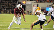 Oct 24, 2025; Blacksburg, Virginia, USA;  Virginia Tech Hokies quarterback Kyron Drones (1) runs the ball for a two point conversion during the second overtime period as California Golden Bears defensive back Dru Polidore Jr. (2)defends at Lane Stadium. Mandatory Credit: Brian Bishop-Imagn Images