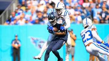 Oct 13, 2024; Nashville, Tennessee, USA;  Indianapolis Colts cornerback Jaylon Jones (40) tackles Tennessee Titans wide receiver DeAndre Hopkins (10) after a made catch during the first half at Nissan Stadium. Mandatory Credit: Steve Roberts-Imagn Images
