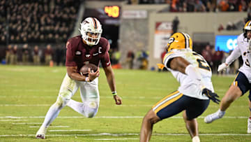 Oct 24, 2025; Blacksburg, Virginia, USA;  Virginia Tech Hokies quarterback Kyron Drones (1) runs the ball for a two point conversion during the second overtime period as California Golden Bears defensive back Dru Polidore Jr. (2)defends at Lane Stadium. Mandatory Credit: Brian Bishop-Imagn Images