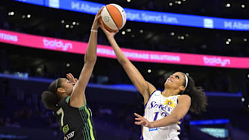 Jul 10, 2025; Los Angeles, California, USA;  Minnesota Lynx forward Anastasiia Olairi Kosu (7) blocks a shot by Los Angeles Sparks guard Rae Burrell (12) in the second half at Crypto.com Arena. Mandatory Credit: Jayne Kamin-Oncea-Imagn Images