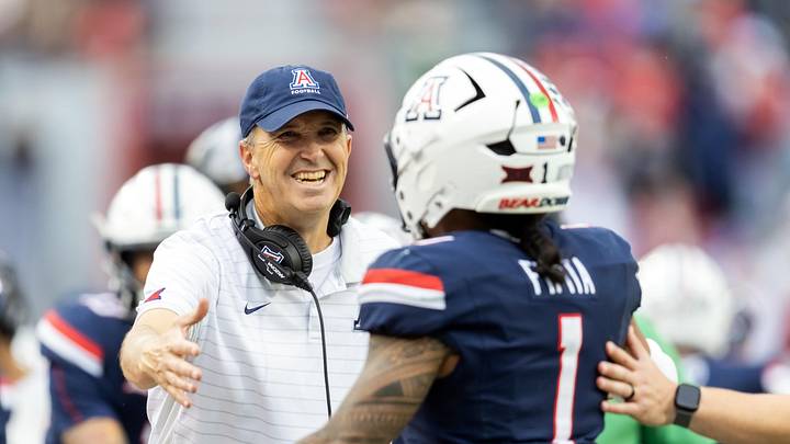 Nov 22, 2025; Tucson, Arizona, USA; Arizona Wildcats head coach Brent Brennan celebrates with quarterback Noah Fifita (1) against the Baylor Bears at Casino Del Sol Stadium. Mandatory Credit: Mark J. Rebilas-Imagn Images