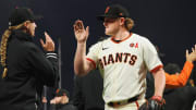 Jul 31, 2024; San Francisco, California, USA; San Francisco Giants starting pitcher Logan Webb high-fives major league coach Alyssa Nakken.