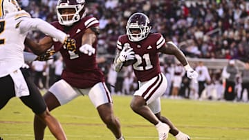 Nov 23, 2024; Starkville, Mississippi, USA; Mississippi State Bulldogs running back Davon Booth (21) runs against the Missouri Tigers during the second quarter at Davis Wade Stadium at Scott Field. Mandatory Credit: Matt Bush-Imagn Images