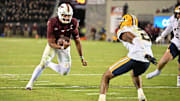 Oct 24, 2025; Blacksburg, Virginia, USA;  Virginia Tech Hokies quarterback Kyron Drones (1) runs the ball for a two point conversion during the second overtime period as California Golden Bears defensive back Dru Polidore Jr. (2)defends at Lane Stadium. Mandatory Credit: Brian Bishop-Imagn Images