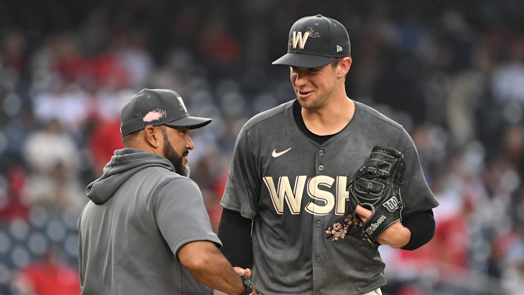 Sep 29, 2024; Washington, District of Columbia, USA; Washington Nationals starting pitcher Jackson Rutledge (79) shakes hands with manager Dave Martinez (4) after getting pulled from the game against the Philadelphia Phillies during the seventh inning at Nationals Park. Mandatory Credit: Rafael Suanes-Imagn Images