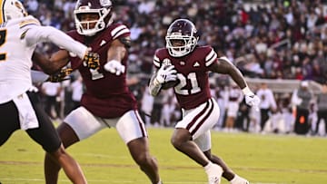 Nov 23, 2024; Starkville, Mississippi, USA; Mississippi State Bulldogs running back Davon Booth (21) runs against the Missouri Tigers during the second quarter at Davis Wade Stadium at Scott Field. Mandatory Credit: Matt Bush-Imagn Images