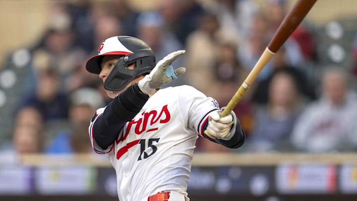 Sep 3, 2025; Minneapolis, Minnesota, USA; Minnesota Twins second baseman Luke Keaschall (15) hits a RBI double against the Chicago White Sox in the first inning at Target Field. Mandatory Credit: Jesse Johnson-Imagn Images