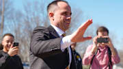 Iowa's new head men's basketball coach Ben McCollum waves at the assembled crowd while walking into his introductory press conference Tuesday, March 25, 2025 at Carver-Hawkeye Arena in Iowa City, Iowa.