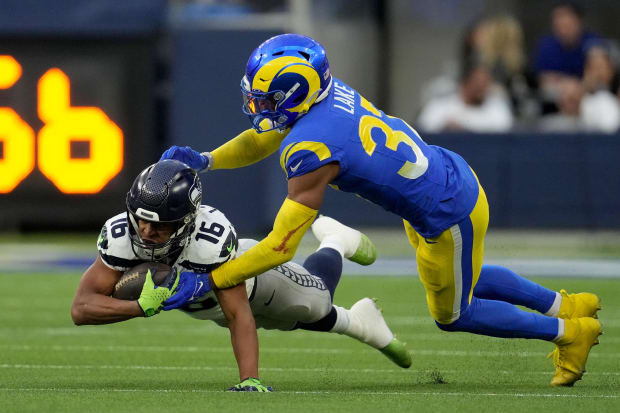 Los Angeles Rams safety Quentin Lake (37) tackles Seattle Seahawks wide receiver Tyler Lockett (16).
