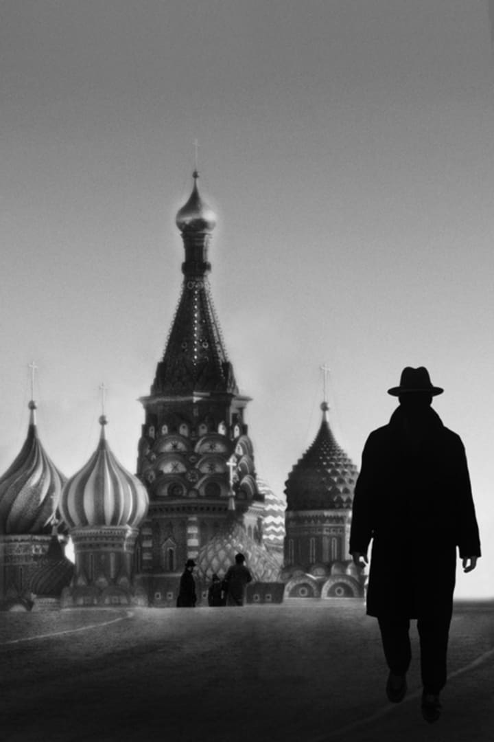 Silhouette of a man in a fedora and trench coat in Red Square in Moscow, Russia