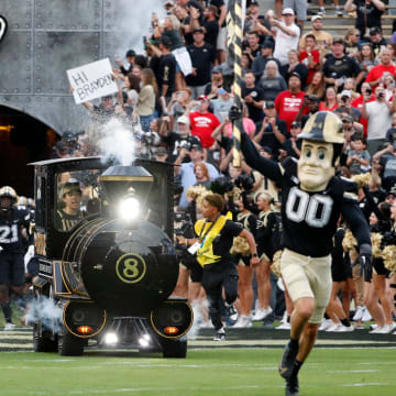 The Purdue Boilermakers make their way to the field 