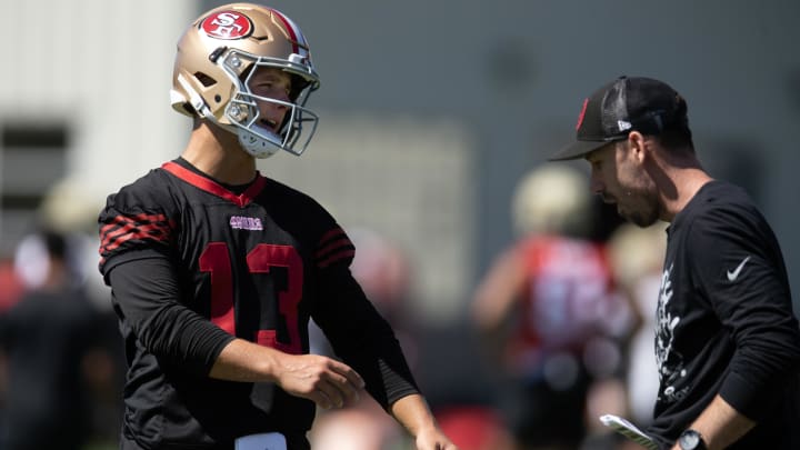 Jul 26, 2024; Santa Clara, CA, USA; San Francisco 49ers quarterback Brock Purdy (13) talks with a coach during Day 4 of training camp at SAP Performance Facility. Mandatory Credit: D. Ross Cameron-USA TODAY Sports