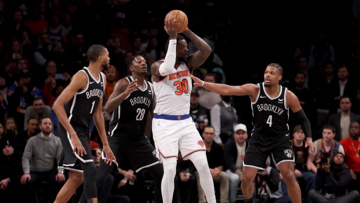 Jan 23, 2024; Brooklyn, New York, USA; New York Knicks forward Julius Randle (30) looks to pass the ball against Brooklyn Nets forwards Mikal Bridges (1) and Dorian Finney-Smith (28) and guard Dennis Smith Jr. (4) during the fourth quarter at Barclays Center. Mandatory Credit: Brad Penner-USA TODAY Sports