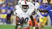 Nov 9, 2024; Pittsburgh, Pennsylvania, USA;  Virginia Cavaliers safety Jonas Sanker (20) returns an interception against the Pittsburgh Panthers during the third quarter at Acrisure Stadium. Mandatory Credit: Charles LeClaire-Imagn Images