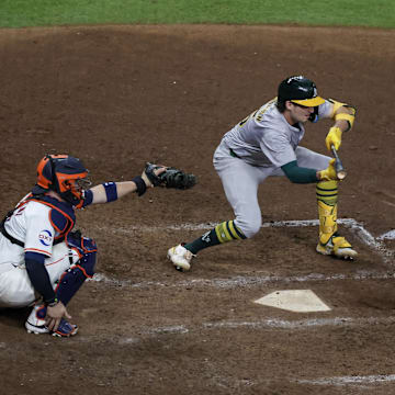 Sep 10, 2024; Houston, Texas, USA; Oakland Athletics shortstop Jacob Wilson (5) bunts safely against the Houston Astros in the 10th inning at Minute Maid Park. Mandatory Credit: Thomas Shea-Imagn Images