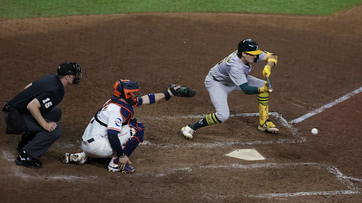 Sep 10, 2024; Houston, Texas, USA; Oakland Athletics shortstop Jacob Wilson (5) bunts safely against the Houston Astros in the 10th inning at Minute Maid Park. Mandatory Credit: Thomas Shea-Imagn Images