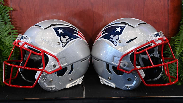 Jan 13, 2025; Foxborough, MA, USA; A pair of New England Patriots helmets sit in front of the podium before a press conference at Gillette Stadium. Mandatory Credit: Eric Canha-Imagn Images Jan 13, 2025; Foxborough, MA, USA; A pair of New England Patriots helmets sit in front of the podium before a press conference at Gillette Stadium. Mandatory Credit: Eric Canha-Imagn Images
