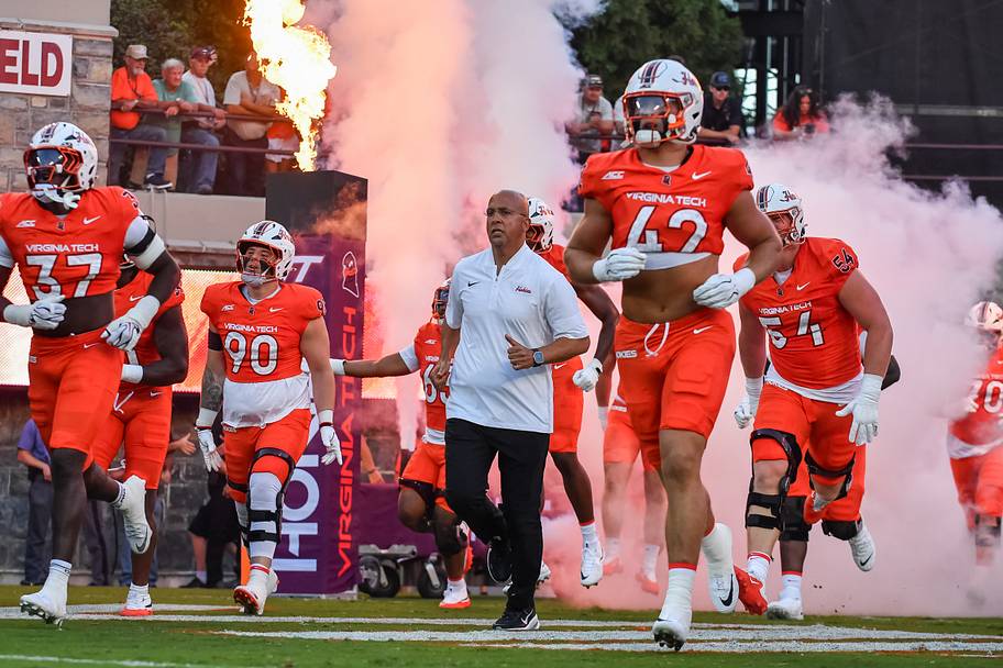 Virginia Tech coach James Franklin runs onto the field.