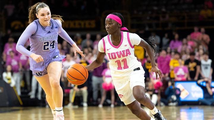 Iowa guard Chit-Chat Wright (11) dribbles down court against Washington guard Elle Ladine (24) Feb. 11, 2026 at Carver-Hawkeye Arena in Iowa City, Iowa.