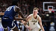 Purdue guard Fletcher Loyer (2) drives past Yale center Samson Aletan (10) during a game at Mackey Arena in November.