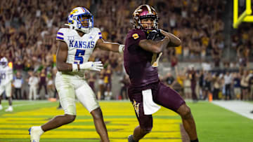 Oct 5, 2024; Tempe, Arizona, USA; Arizona State Sun Devils wide receiver Jordyn Tyson (0) scores a touchdown against Kansas Jayhawks safety O.J. Burroughs (5) in the fourth quarter at Mountain America Stadium. Mandatory Credit: Mark J. Rebilas-Imagn Images