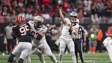 Sep 29, 2024; Atlanta, Georgia, USA; New Orleans Saints quarterback Derek Carr (4) passes the ball against the Atlanta Falcons during the second half at Mercedes-Benz Stadium.