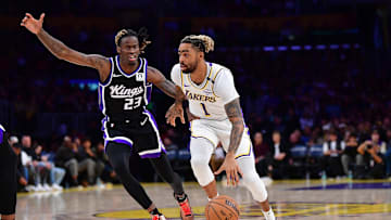 Dec 28, 2024; Los Angeles, California, USA; Los Angeles Lakers guard D'Angelo Russell (1) moves the ball against Sacramento Kings guard Keon Ellis (23) during the second half at Crypto.com Arena. Mandatory Credit: Gary A. Vasquez-Imagn Images