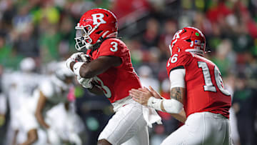 Rutgers Scarlet Knights running back Antwan Raymond takes a hand off from quarterback Athan Kaliakmanis