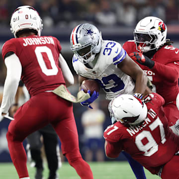 Nov 3, 2025; Arlington, Texas, USA; Dallas Cowboys running back Javonte Williams (33) runs against Arizona Cardinals defensive tackle Walter Nolen III (97) in the second half at AT&T Stadium. Mandatory Credit: Kevin Jairaj-Imagn Images