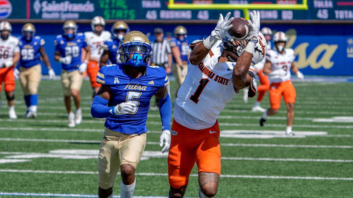 Oklahoma State wide receiver De'Zhaun Stribling (1) receives the ball past Tulsa cornerback Keuan Parker (5) in the first half during an NCAA football game between Oklahoma State and Tulsa in Tulsa, Okla., on Saturday, Sept. 14, 2024.