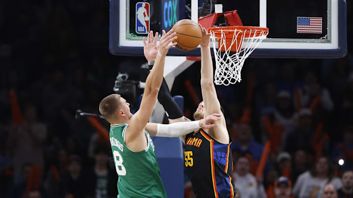 Jan 5, 2025; Oklahoma City, Oklahoma, USA; Oklahoma City Thunder center Isaiah Hartenstein (55) blocks a shot by Boston Celtics center Kristaps Porzingis (8) during the fourth quarter at Paycom Center. Mandatory Credit: Alonzo Adams-Imagn Images Jan 5, 2025; Oklahoma City, Oklahoma, USA; Oklahoma City Thunder center Isaiah Hartenstein (55) blocks a shot by Boston Celtics center Kristaps Porzingis (8) during the fourth quarter at Paycom Center. Mandatory Credit: Alonzo Adams-Imagn Images