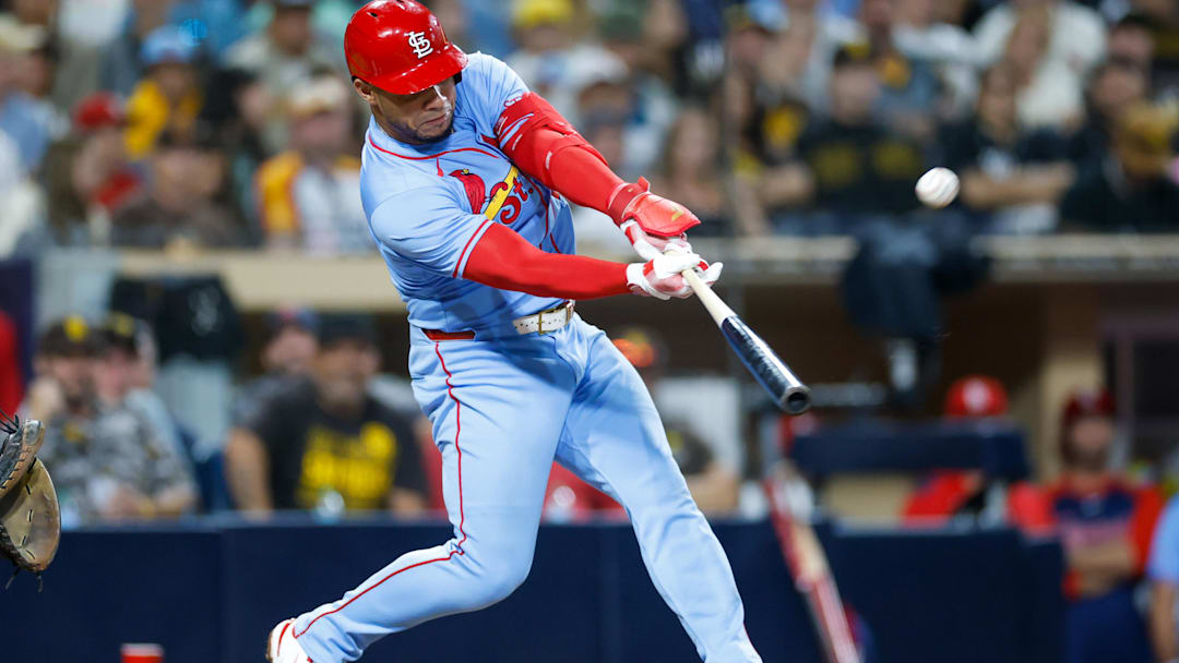 Aug 2, 2025; San Diego, California, USA; St. Louis Cardinals first baseman Willson Contreras (40) hits a sacrifice fly during the ninth inning against the San Diego Padres at Petco Park. Mandatory Credit: David Frerker-Imagn Images