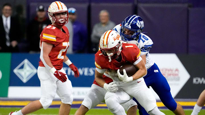 Van Meter’s Brayden Fennessey (10) tackles Kuemper Catholic’s Brayton Alford (1) after an interception Nov. 21, 2025 during the Class 2A high school state football championship at the UNI-Dome in Cedar Falls, Iowa.