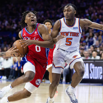 Mar 2, 2022; Philadelphia, Pennsylvania, USA; Philadelphia 76ers guard Tyrese Maxey (0) moves with the ball against New York Knicks guard Immanuel Quickley (5) and guard Evan Fournier (13) during the third quarter at Wells Fargo Center. Mandatory Credit: Bill Streicher-USA TODAY Sports