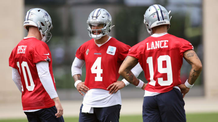 Jun 4, 2024; Frisco, TX, USA;  Dallas Cowboys quarterback Cooper Rush (10) and quarterback Dak Prescott (4) and quarterback Trey Lance (19) talk during practice at the Ford Center at the Star Training Facility in Frisco, Texas. 