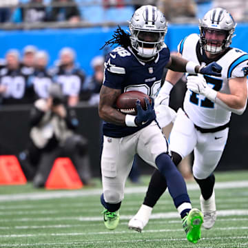 Dallas Cowboys wide receiver CeeDee Lamb with the ball as Carolina Panthers linebacker Josey Jewell defends.