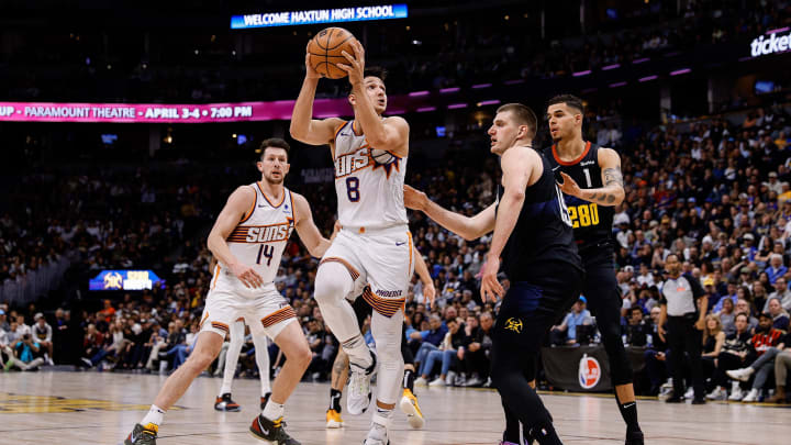 Mar 27, 2024; Denver, Colorado, USA; Phoenix Suns guard Grayson Allen (8) attempts a shot against Denver Nuggets center Nikola Jokic (15) and forward Michael Porter Jr. (1) as forward Drew Eubanks (14) defends in the fourth quarter at Ball Arena. Mandatory Credit: Isaiah J. Downing-USA TODAY Sports