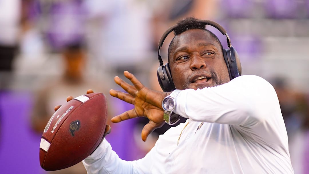 Oct 4, 2025; Fort Worth, Texas, USA; Colorado Buffaloes defensive pass rush coordinator Warren Sapp plays catch on the sidelines prior to a game between the TCU Horned Frogs and the Colorado Buffaloes at Amon G. Carter Stadium. Mandatory Credit: Raymond Carlin III-Imagn Images