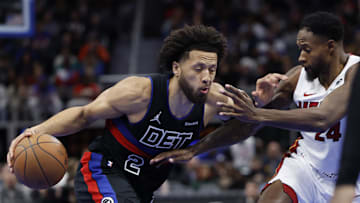 Nov 12, 2024; Detroit, Michigan, USA;  Detroit Pistons guard Cade Cunningham (2) dribbles defended by Miami Heat forward Haywood Highsmith (24) in the second half at Little Caesars Arena. Mandatory Credit: Rick Osentoski-Imagn Images