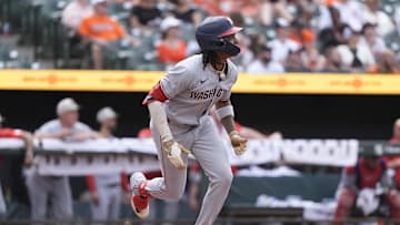 May 18, 2025; Baltimore, Maryland, USA; Washington Nationals shortstop CJ Abrams (5) hits a double against the Baltimore Orioles during the ninth inning at Oriole Park at Camden Yards. 